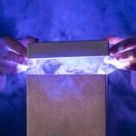 A person opening a glowing, magical wooden box in a dimly lit room, symbolizing the hidden power of a product's story.