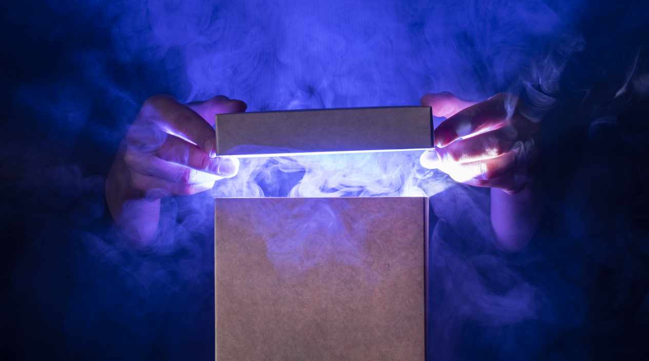A person opening a glowing, magical wooden box in a dimly lit room, symbolizing the hidden power of a product's story.